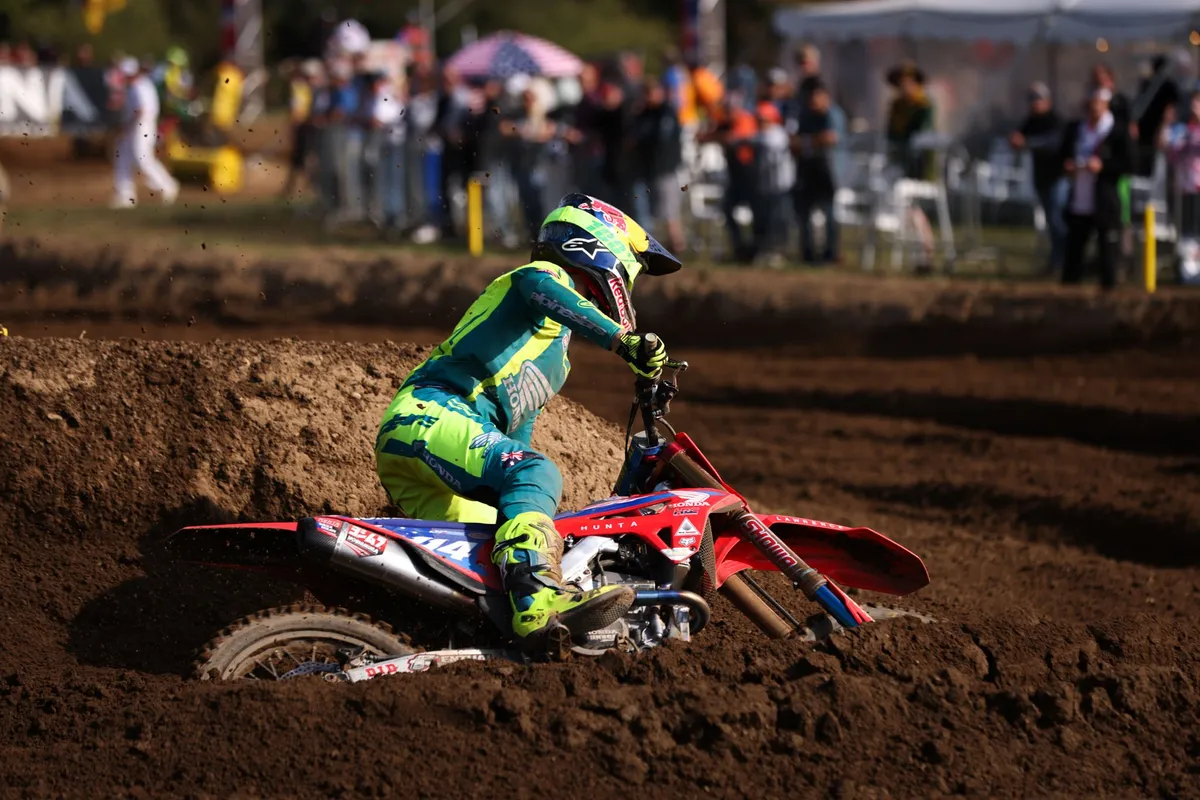 Motocross rider railing a rut in front of the crowd