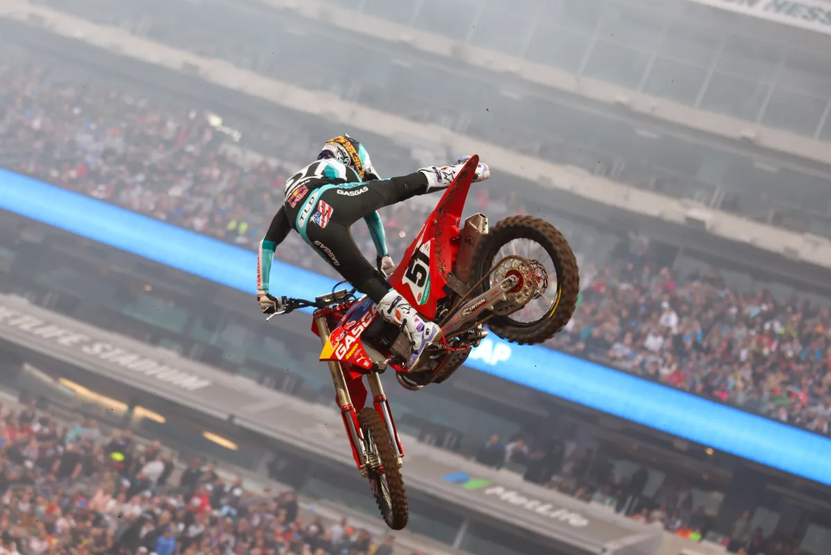 Supercross rider whipping a jump inside MetLife Stadium