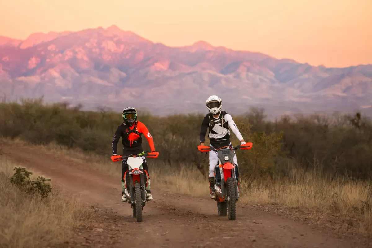 Two dirt bike riders at sunset in Arizona