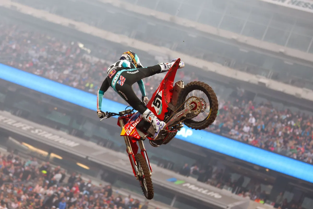 Supercross rider whipping a jump inside MetLife Stadium