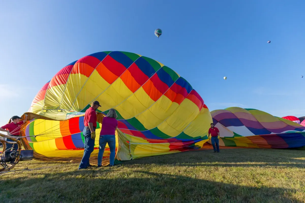 Crew guiding a balloon upright with a rope