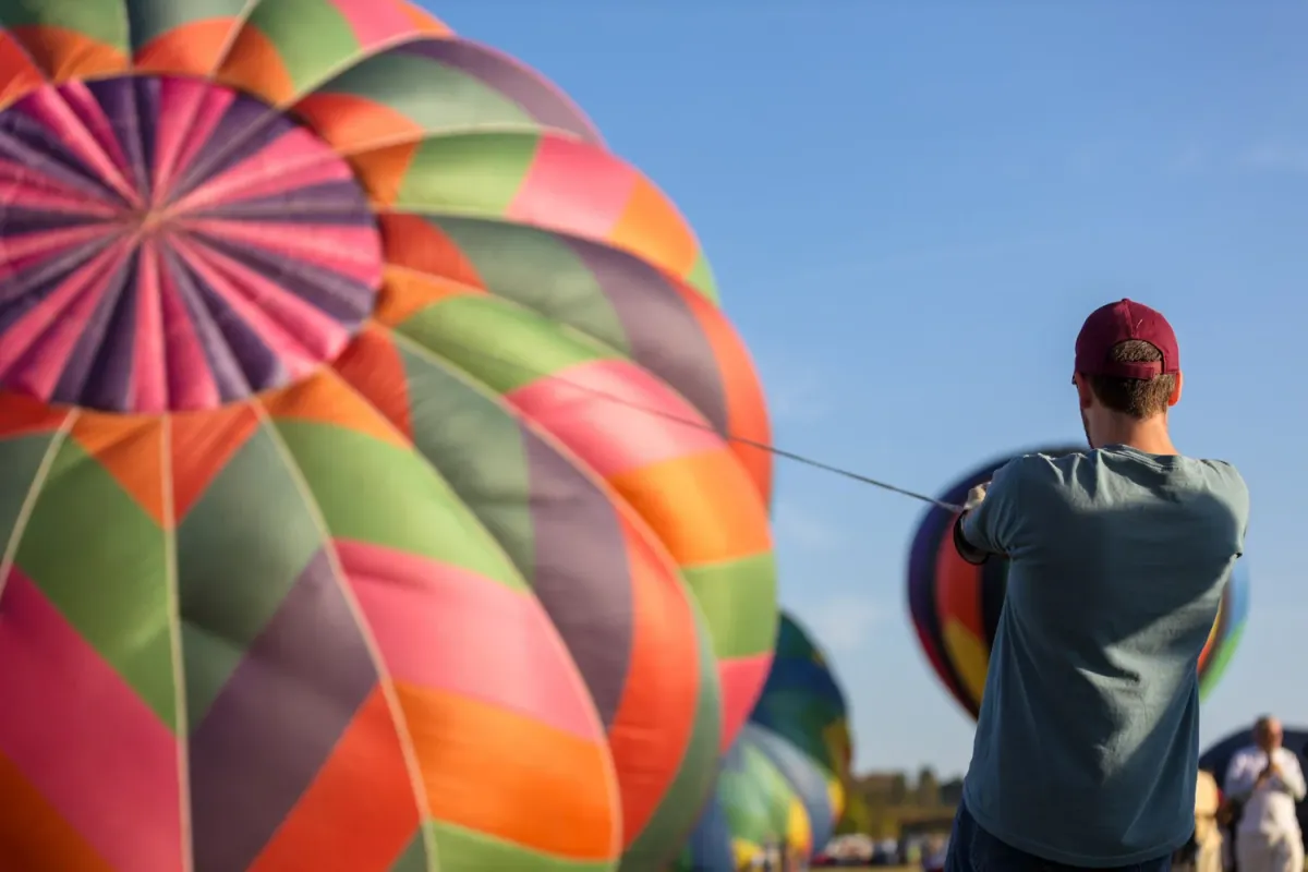 Balloons lifting off into the morning sky