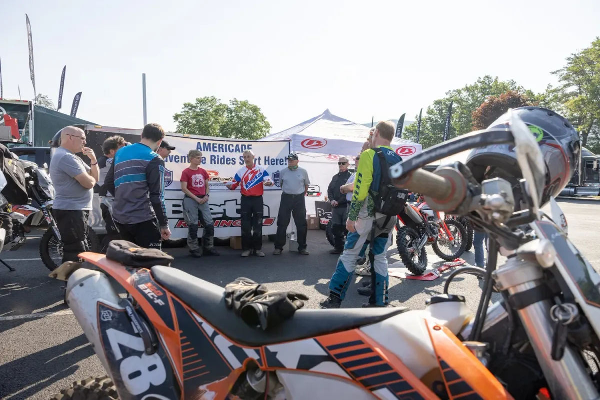 Riders gathered for a briefing beside their bikes