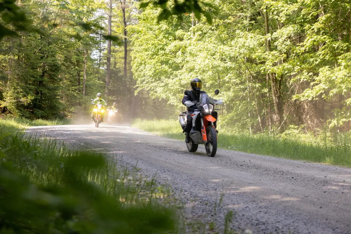 Adventure motorcycle rider on a forest dirt road