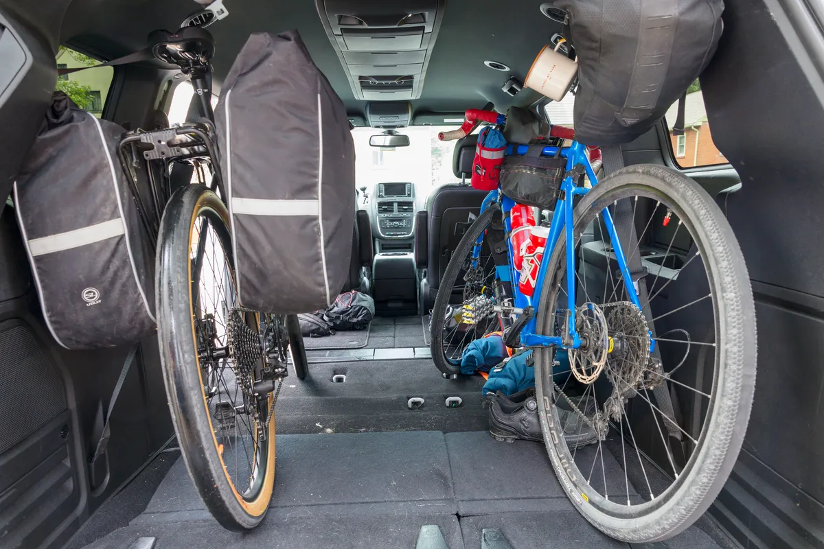 Two loaded bikes and panniers packed into the back of a van