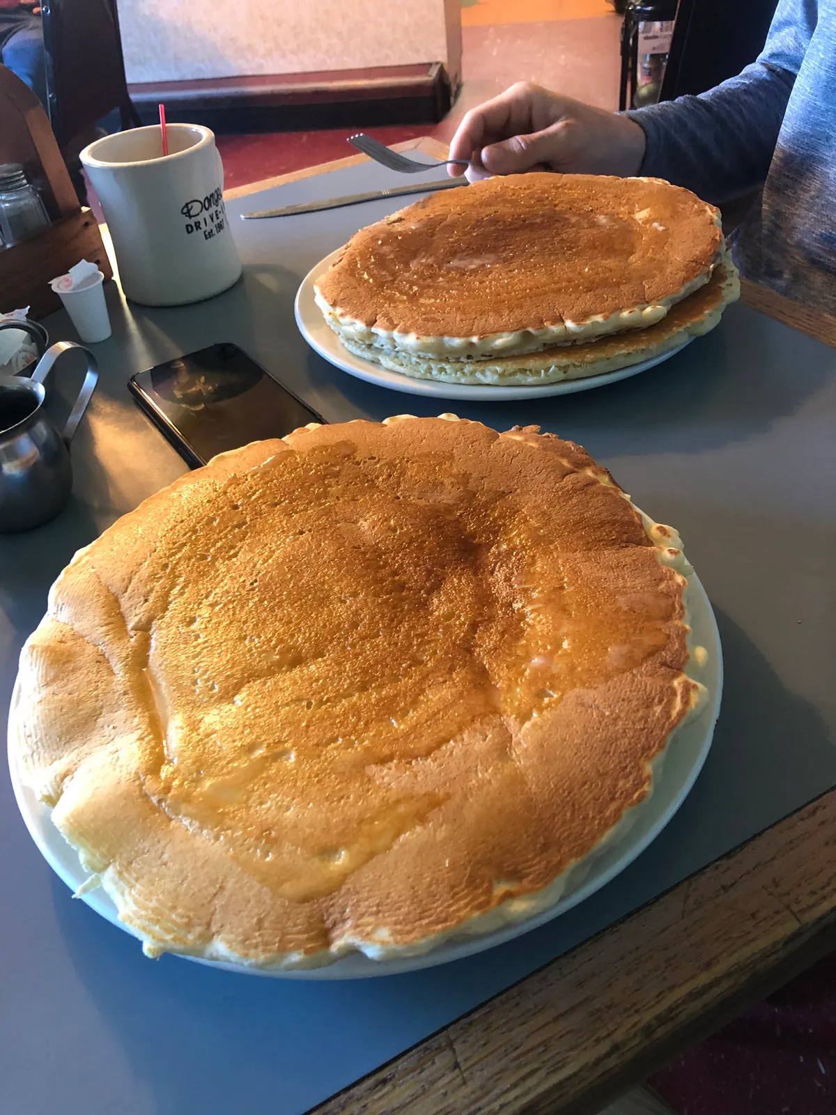 A plate of huge pancakes at a diner