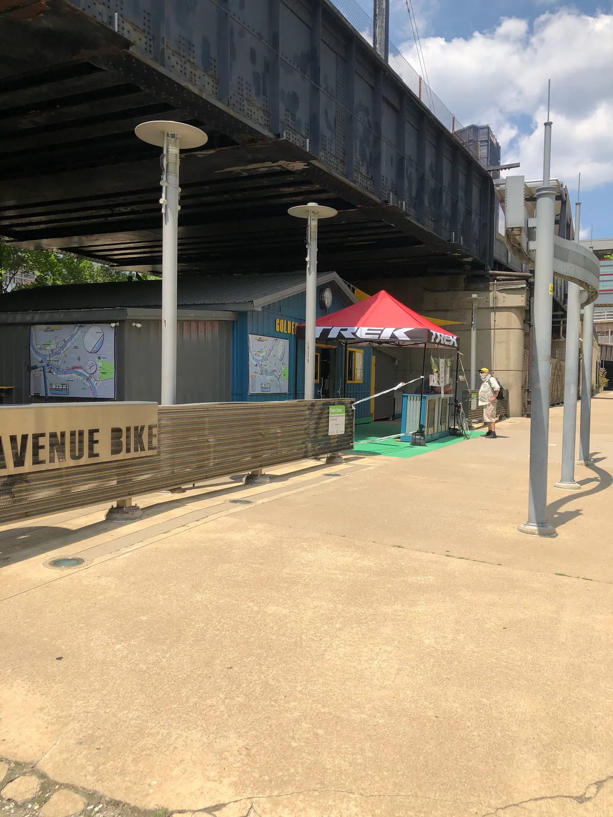 Golden Triangle Bike shop on the riverfront trail with a red Trek tent