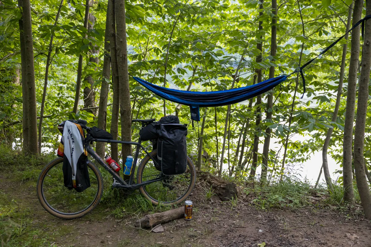 Hammock strung between trees at a towpath campsite