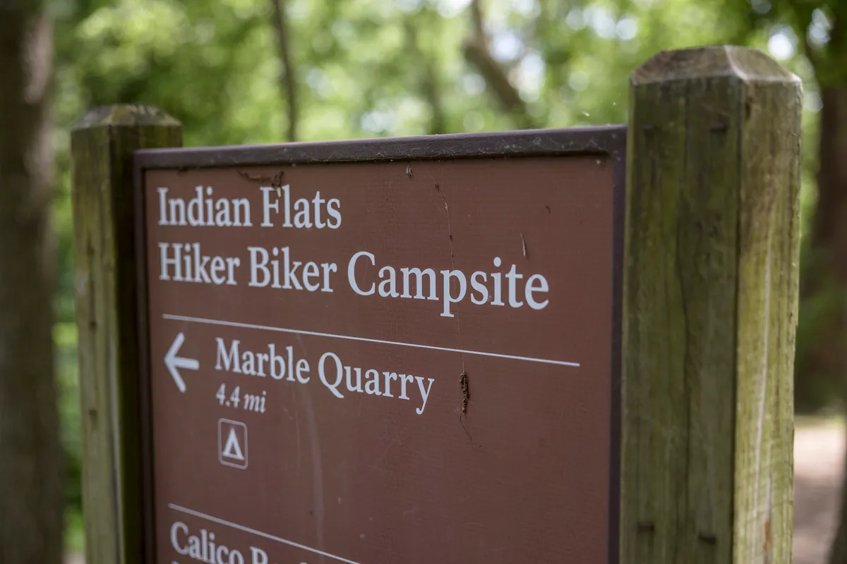 Wooden sign for Indian Flats Hiker Biker Campsite, Marble Quarry 4.4 miles