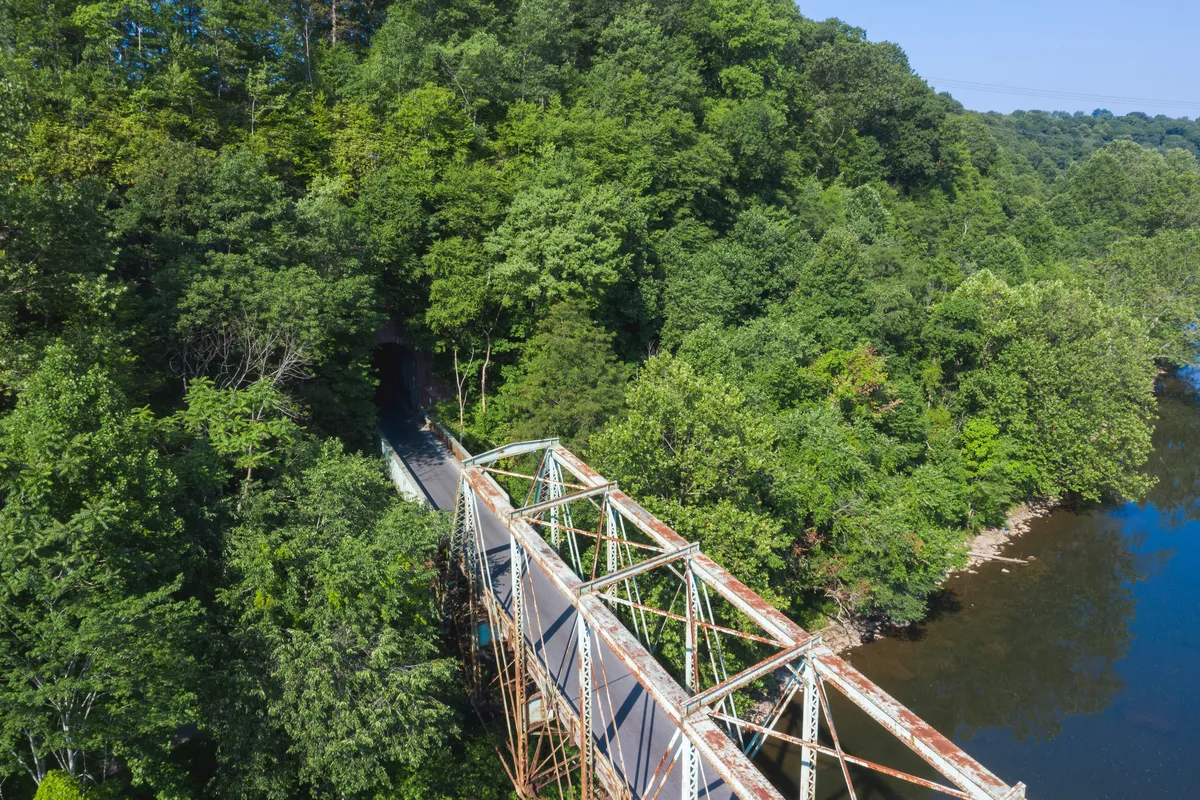 Drone view of the Layton truss bridge running straight into a tunnel in the hillside