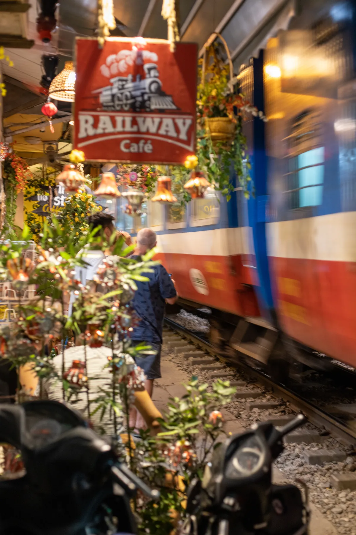 Train rushing past the Railway Cafe sign