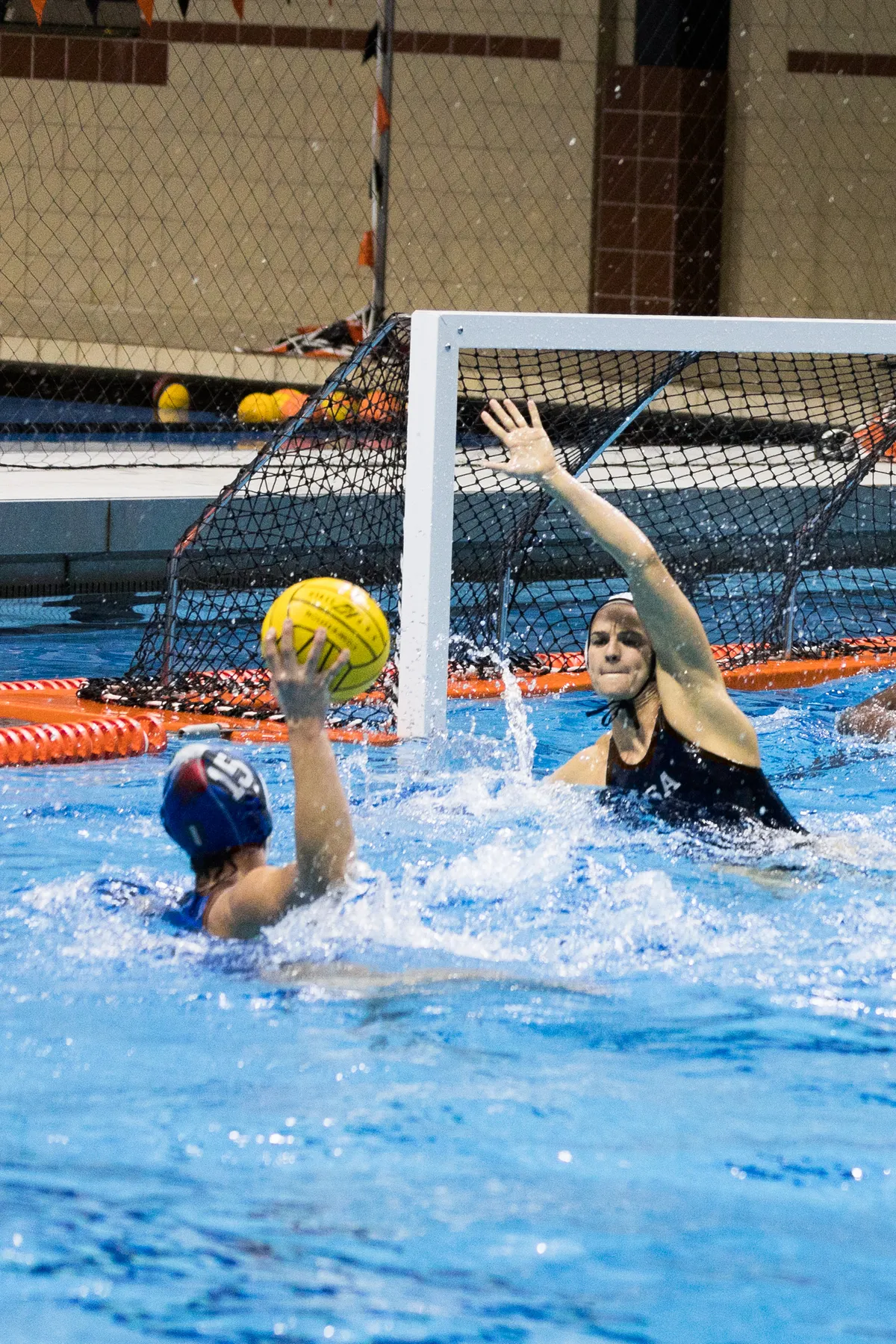USA defender with her hand up as an Italian player shoots