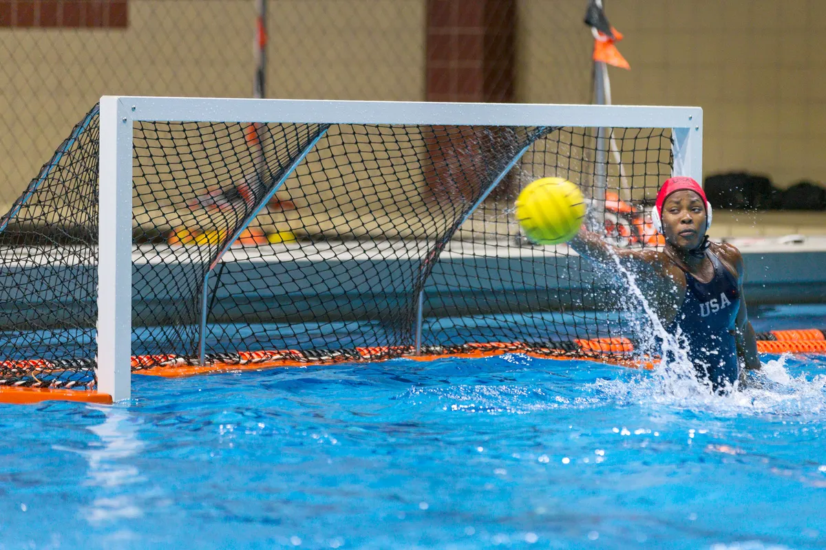 USA goalkeeper stretching for the ball beside the post