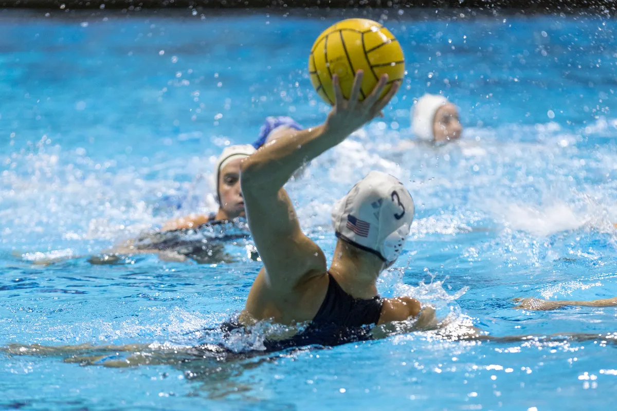 USA number 3 raising the ball overhead to pass