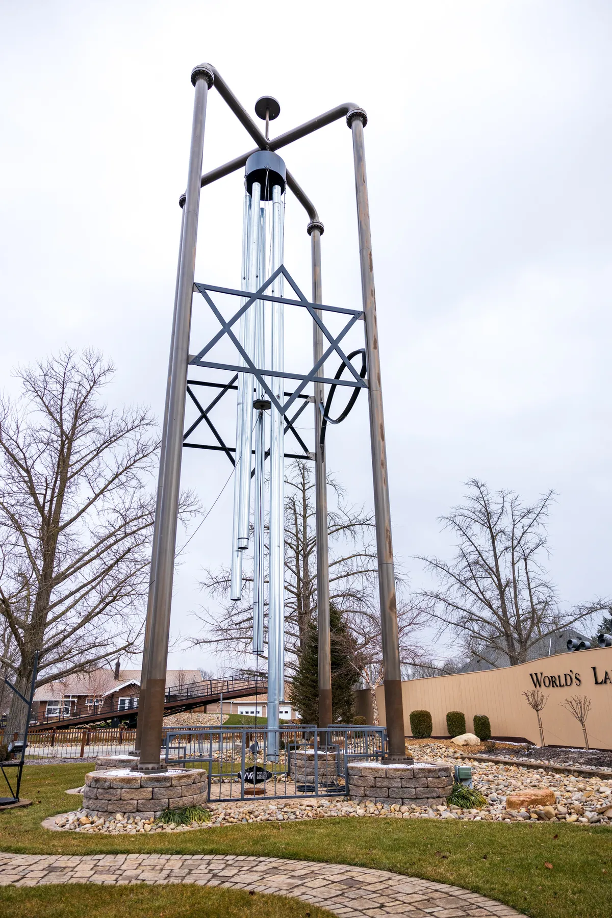 The world's largest wind chime towering over a small park on a grey winter day