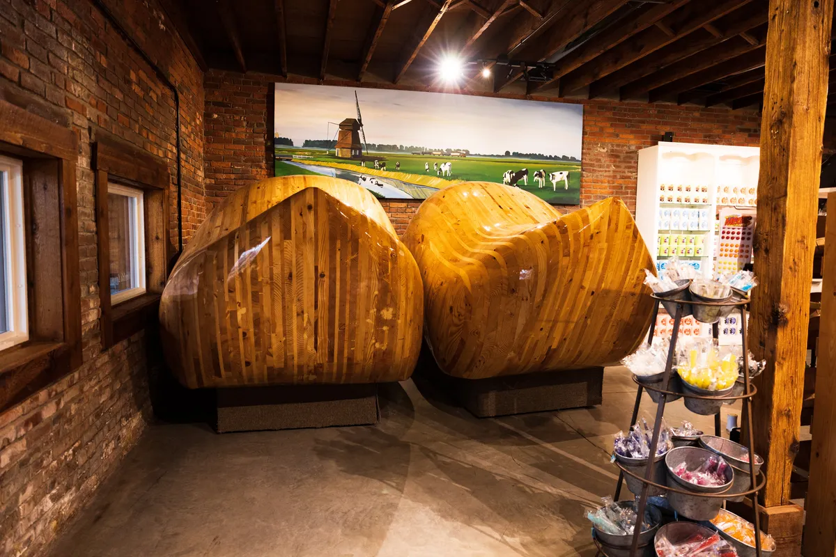 Pair of giant wooden Dutch shoes inside a brick shop